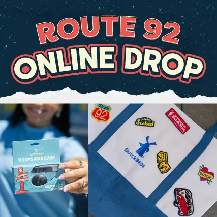 Route 92 Online Drop promotional image showing a keepsake disposable camera and a blue tote bag with Dutch Bros stickers.