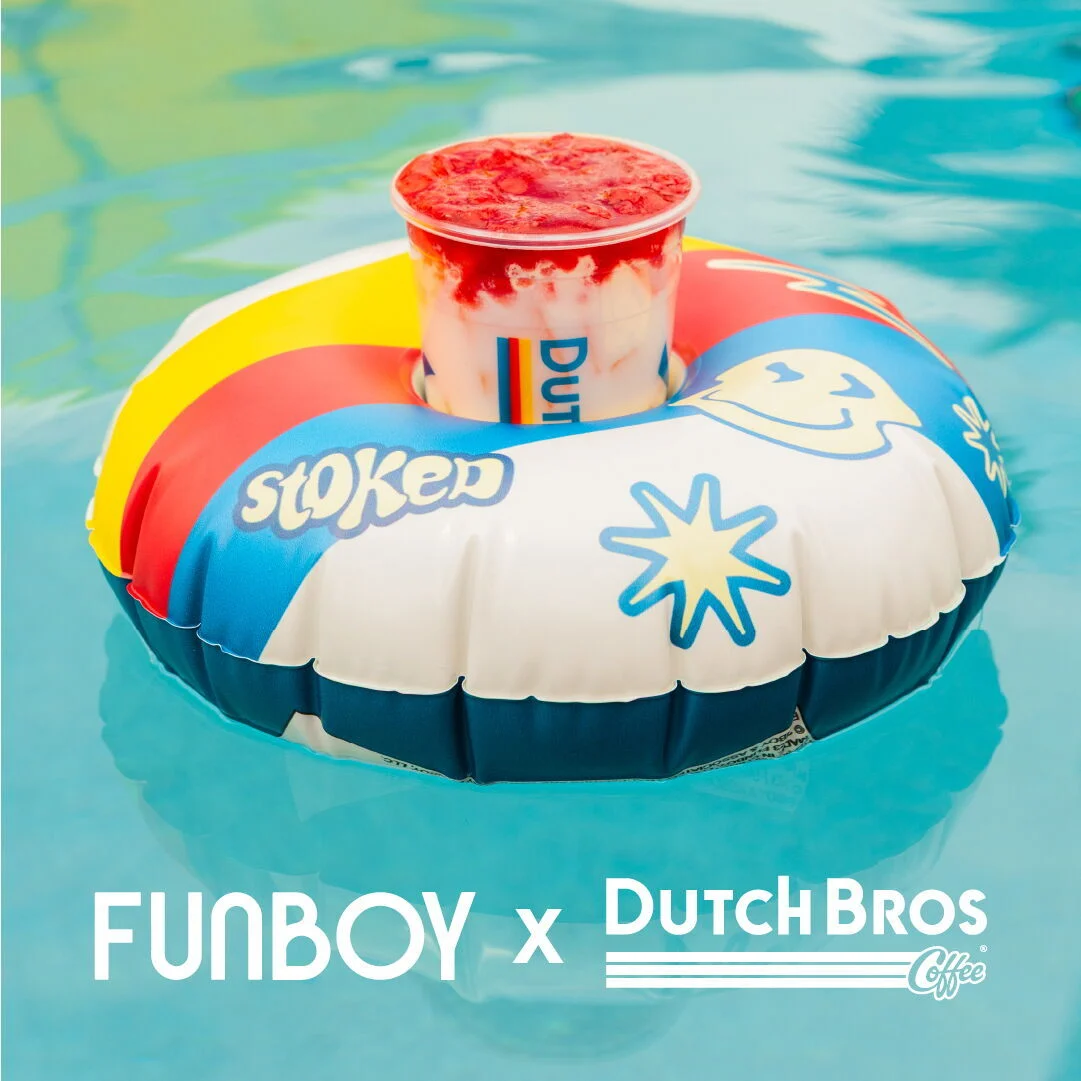 Dutch Bros drink with red topping floating in colorful pool float on turquoise water, FUNBOY x Dutch Bros collaboration.