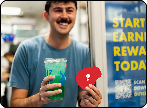 dutch bros broista holding a mystery sticker and a drink 