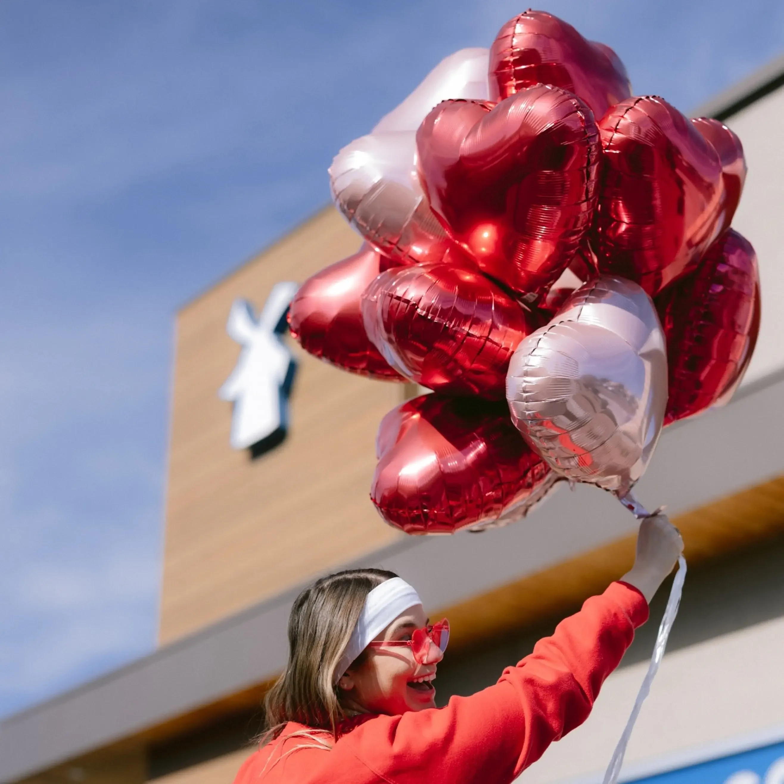 dutch bros broista holding heart shaped balloons