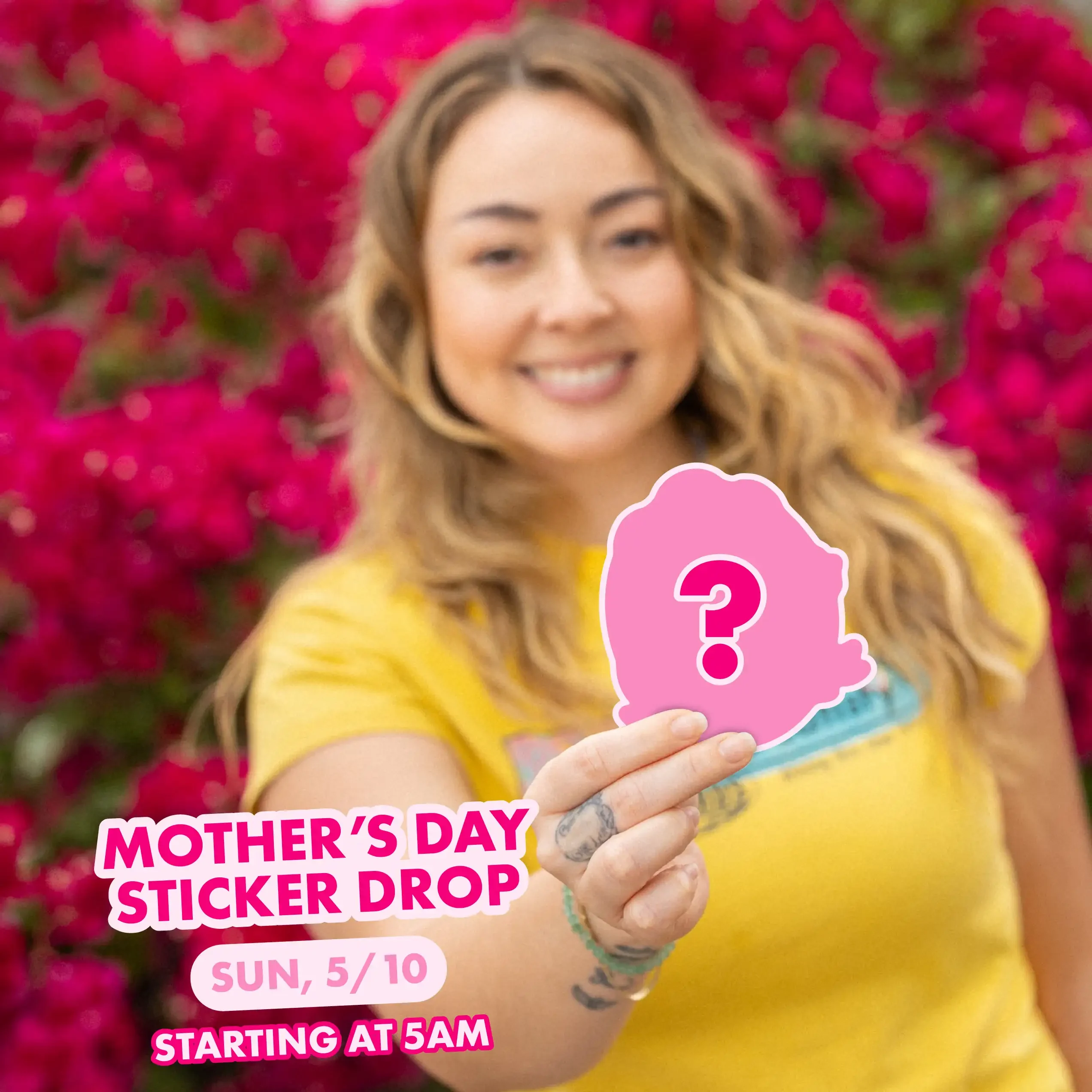 Woman in yellow shirt holding a pink mystery sticker in front of pink flowers. Text reads Mother's Day Sticker Drop, Sun 5/10 at 5AM.