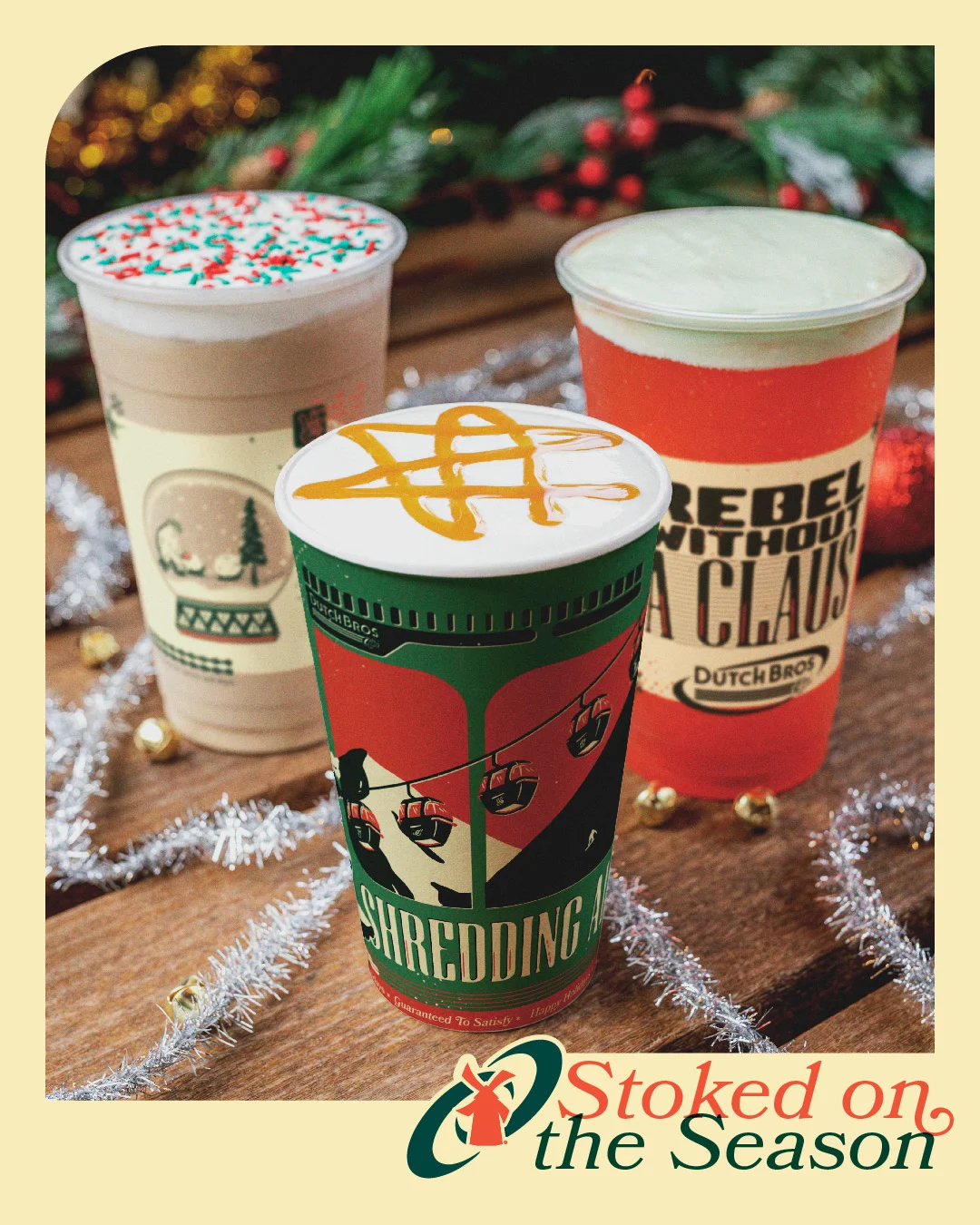 Three festive Dutch Bros coffee drinks with holiday decorations and "Stoked on the Season" text at bottom.