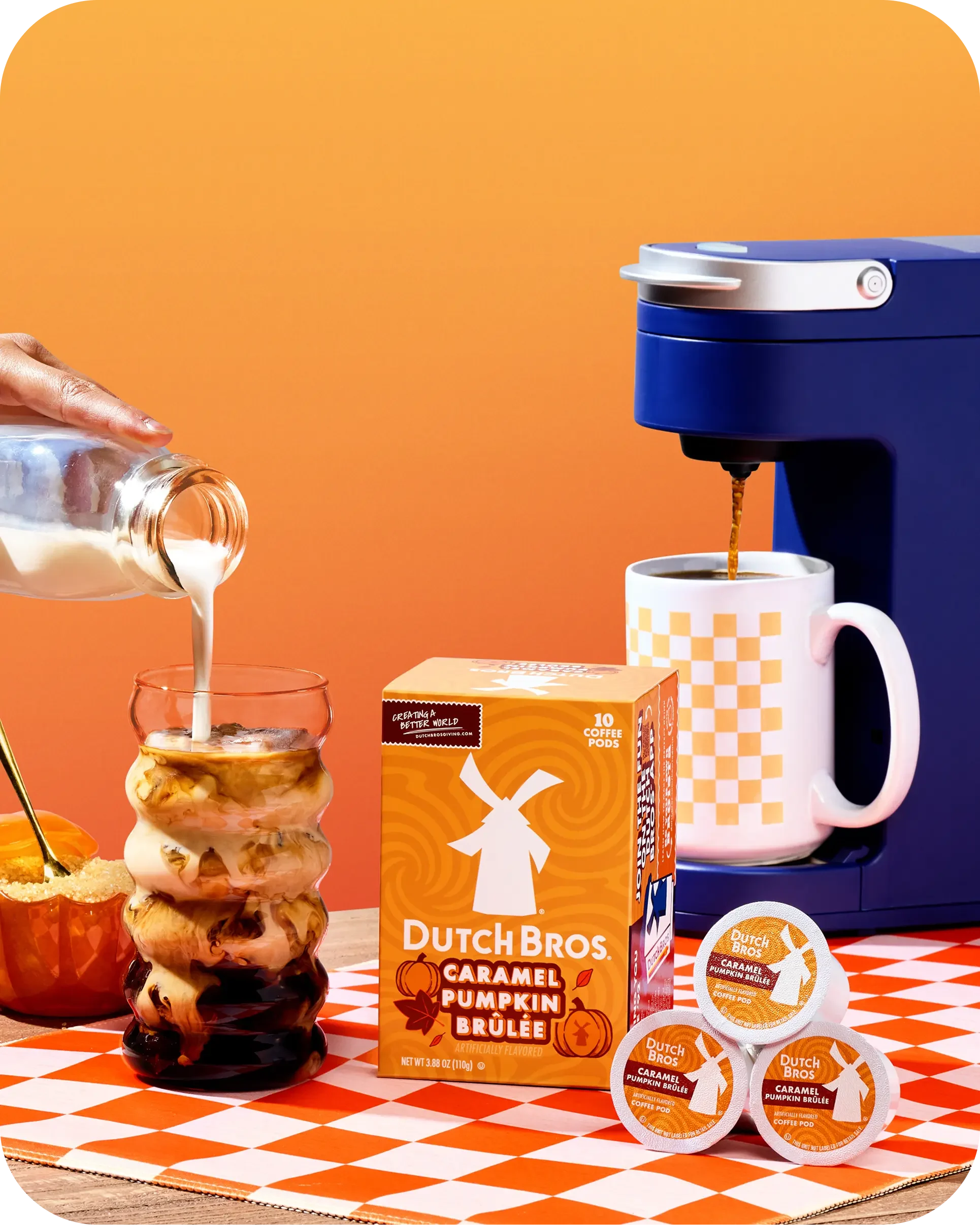 Dutch Bros Caramel Pumpkin Brûlée coffee pods box with K-cups, a blue single-serve brewer, and cream being poured into a glass.