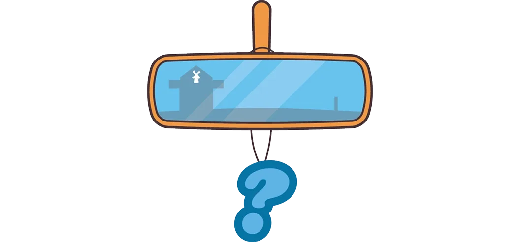 A car rearview mirror with a windmill reflection and a blue question mark air freshener hanging from it.