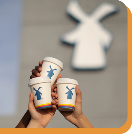 3 coffees cheersing in front of dutch bros