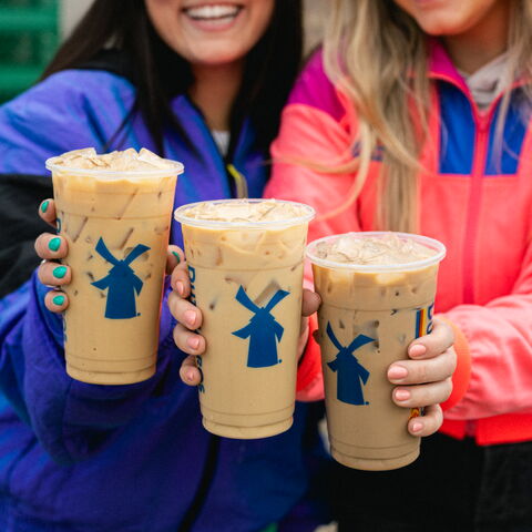 Two smiling Broistas with protein coffees in hand.