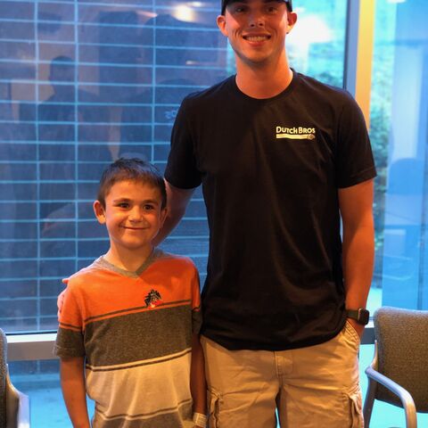 A Dutch Bros broista stands next to a young man who he donated his kidney