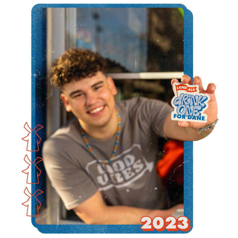 A Dutch Bros broista holds a Drink One For Dane sticker