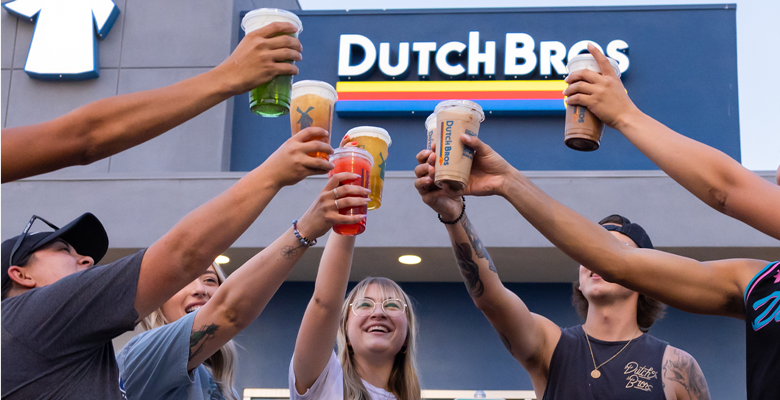 A group of Dutch Bros coffee customers join in a cheers